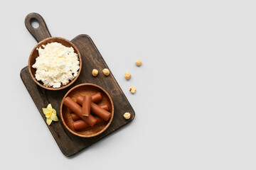 Board with tasty chocolate glazed curd snacks with vanilla flavor and cottage cheese on grey background