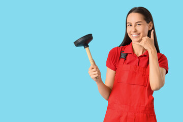 Female plumber with plunger showing 