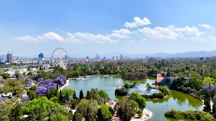 City skyline with a river flowing through it crossed by an arched bridge