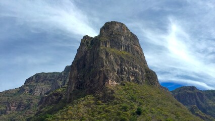Majestic mountain rising above a lush grassy hillside