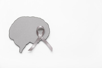Paper brain with grey awareness ribbon on white background. Cancer concept