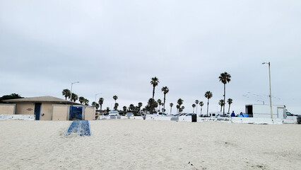 
Gloomy early Summer morning at South Mission Park Beach with a view at a parking lot and public facilities, San Diego, California