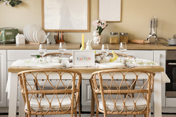 Dining table set for Easter with flowers in kitchen