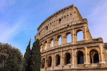 Obraz premium Panoramic view of old Colosseum in Rome. Beautiful popular of ancient landmark. Famous card of city of Rome, Italy. High quality photo