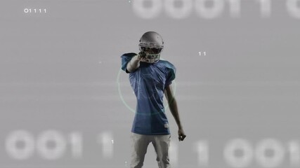 Football player standing against gray set receiving binary circuit overlay then pointing forward - Powered by Adobe