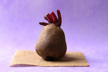 Fresh beetroot on purple background, Imperfectly shape