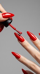 Applying Vibrant Red Nail Polish A Close-Up View of Manicured Nails