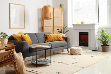 Cozy interior of living room with fireplace, table and sofa