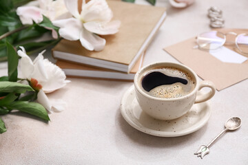 Composition with books, cup of coffee and peony flowers on beige grunge background, closeup