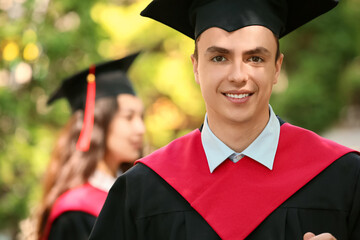 Male graduating student outdoors, closeup