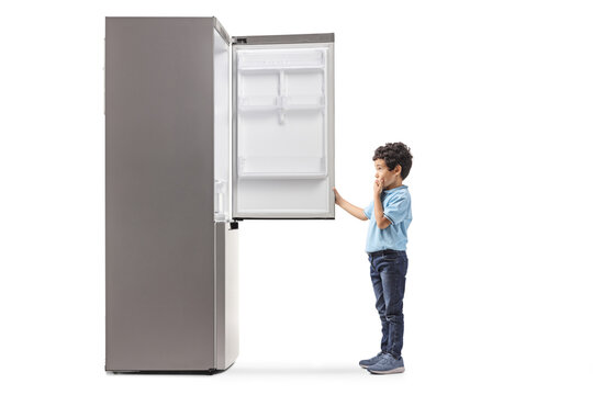 Full length profile shot of a boy looking at an empty fridge