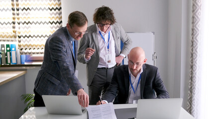The director of the company discusses with a lawyer and a personal assistant the details of an important contract