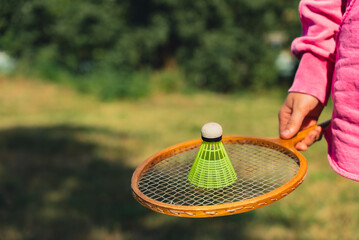 Unrecognizable woman playing with Wooden badminton rackets and shuttlecocks soft focus concept....