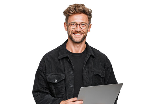 A man wearing glasses and a black jacket is smiling and holding a laptop