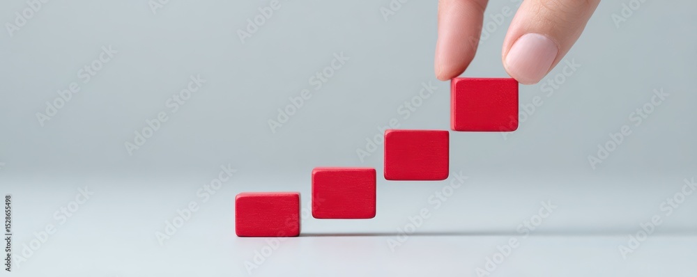 Poster hand placing red blocks in ascending order on gray background for business and growth concepts