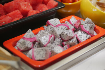 Colorful dragon fruit slices on a buffet table