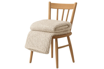 Soft knitted blanket draped over rustic wooden chair, creating inviting home interior atmosphere