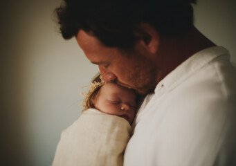 Father and baby child Embracing in Natural Light – Intimate Father's Day Moment