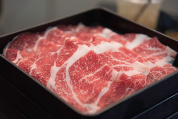 shabu-shabu or sukiyaki. Beef slice on top of hot pot, Fresh beef slices with ingredients...