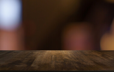 Empty wood table top and blur of restaurant background selective focus product display