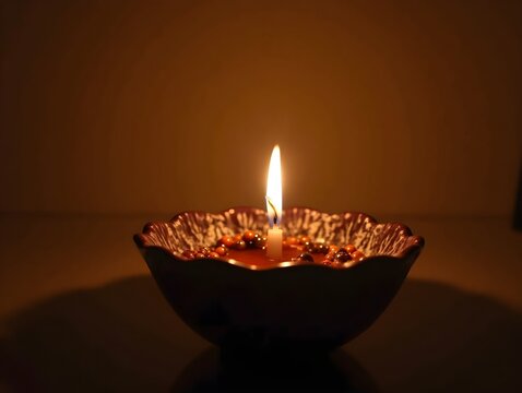 Warm Glow of Candlelight in Ornate Ceramic Bowl with Decorative Beads for Cozy Home Decor