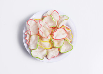 Deep-fried kerupuk bawang or Garlic crackers in a white bowl, an Indonesian cracker made from tapioca flour and flavored with garlic or prawn and come in various edge colors. 