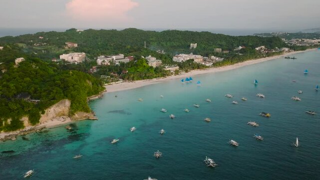 Boracay White Beach. Boats and paraw sailing activities over the turquoise sea water. Philippines.