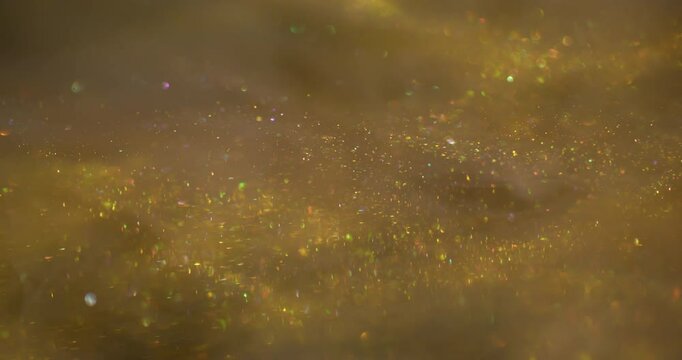 Sparkling flow. Art gleam. Dust stream mix ink haze emulsion. Golden sequins color glisten texture abstract blur scintilla background.