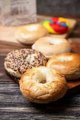 Closeup view of a collection of bagel breads with various kinds on a wooden board