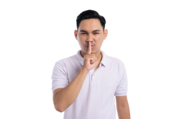 Young man making shushing gesture with finger on lips asking for silence with serious expression isolated on transparent background