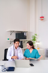 Asian Doctor and Nurse Reviewing Medical Records in Office Healthcare Team Discussing Patient...
