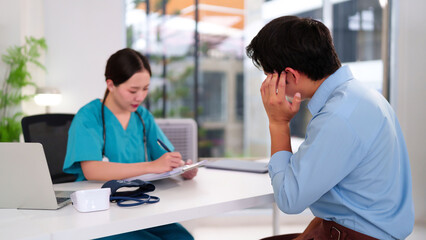 Asian Man Doctor's Office Consultation with Female Physician Patient Worried Medical Treatment...