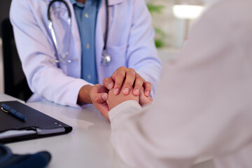 Doctor Comforting Patient: A doctor gently holds a patient's hands, offering comfort and...