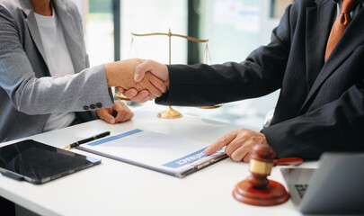 Woman lawyer hand and women client shaking hand collaborate on working agreements with contract...