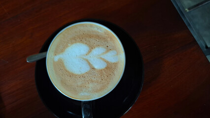 patterns made by skillfully pouring steamed milk onto the surface of a latte