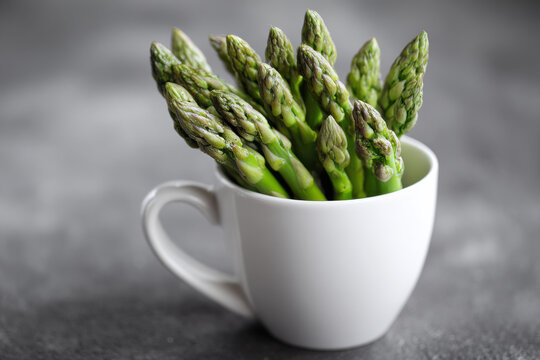 Asparagus in a white cup - Powered by Adobe