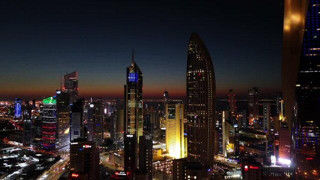 A breathtaking aerial view of a vibrant city skyline at dusk, featuring illuminated skyscrapers and urban lights. Perfect for cinematic projects and architectural themes.