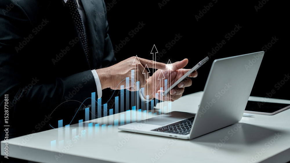 Poster businessman using a cellphone with a virtual graph and upward arrow. laptop and tablet on the table.