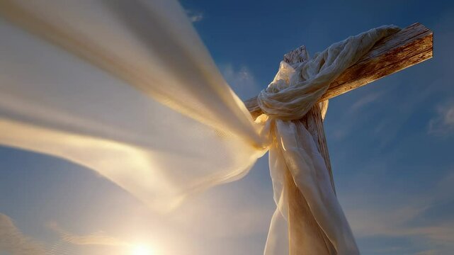 Closeup of a cross dd in a white veil, its surface reflecting the golden rays of the sunrise and pointing towards the heavens.