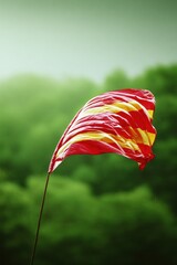 Waving flag against a blurred forest