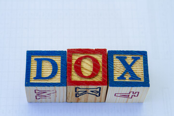 The term dox displayed visually on a clear background with copy space