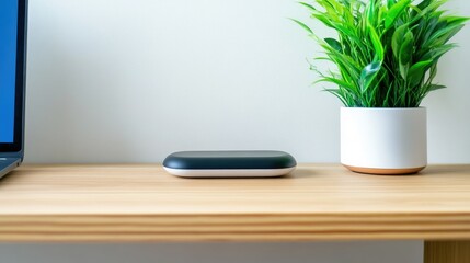 Modern device on light wood shelf