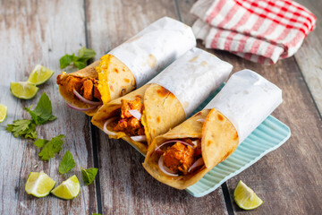 Egg chicken roll is a popular street food made with a flaky paratha, spiced chicken, egg layer, onions, and sauces, wrapped and served hot.
