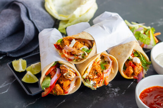 Chicken shawarma roll is a Middle Eastern wrap made with spiced grilled chicken, garlic sauce, pickled veggies, and flatbread, served warm and flavorful.
