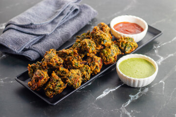 Palak ke pakore are crispy, deep-fried spinach fritters made with besan, spices, and fresh spinach leaves, served hot with chutney or tea.

