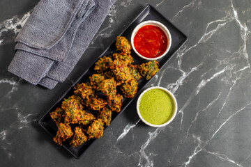 Palak ke pakore are crispy, deep-fried spinach fritters made with besan, spices, and fresh spinach leaves, served hot with chutney or tea.
