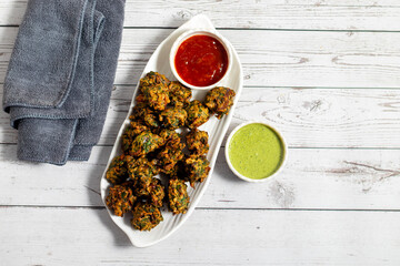 Palak ke pakore are crispy, deep-fried spinach fritters made with besan, spices, and fresh spinach leaves, served hot with chutney or tea.
