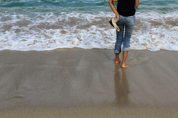 Half body of a young lady standing on the beach.