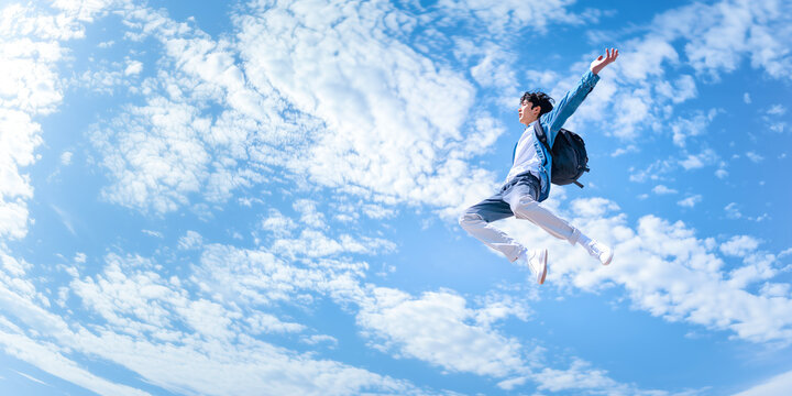 Dynamic male jump scene and blue sky.