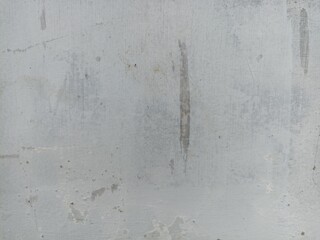 Weathered Concrete Wall with Faded Marks. A textured concrete wall with worn paint and stains, ideal for use in backgrounds, design projects, and industrial themes